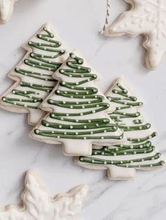 Festively Decorated Evergreen Tree Cookies with Icing and Pearl Accents.