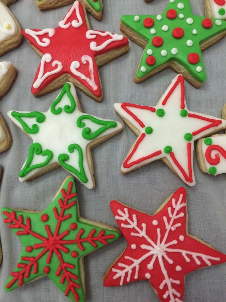 Vibrant Star-Shaped Holiday Cookies with Intricate Icing Designs.