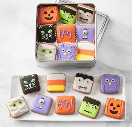 Vibrant Halloween-Themed Cookies in Decorative Tin with Playful Designs.