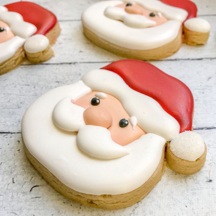 Whimsical Santa Face Cookies: Cheerful Holiday Delights with Intricate Icing Designs.