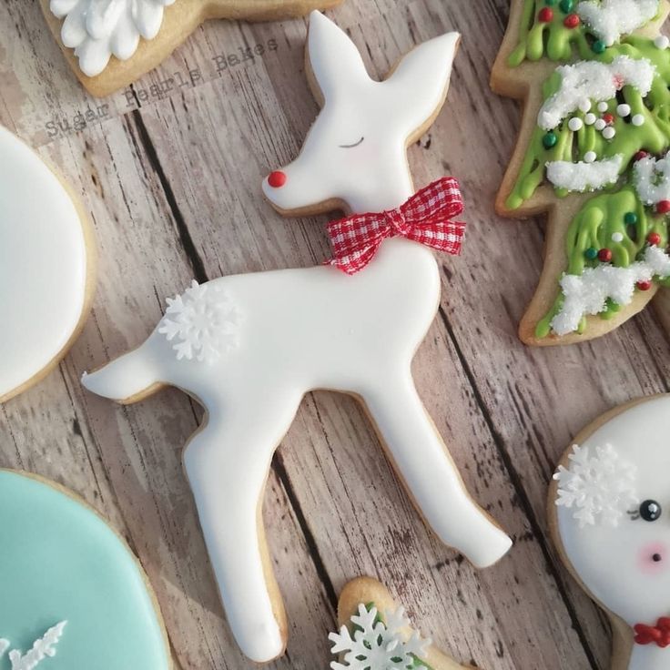 Charming White Deer Holiday Cookie Decoration with Snowflake Icing and Red Bow.