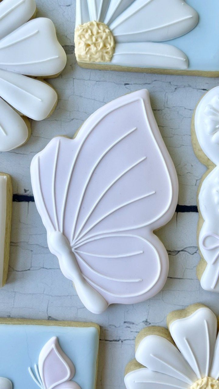 Delicate Butterfly-Shaped Cookies: A Whimsical Spring Treat with Floral Elegance.