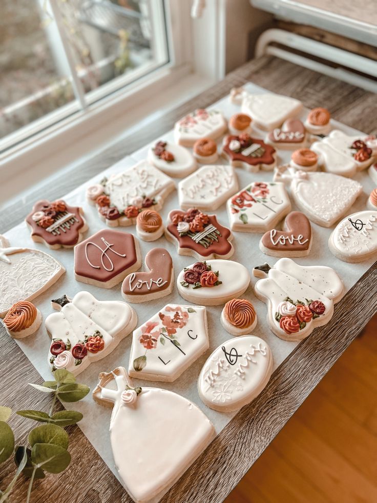 Exquisite Cookie Designs: Intricate Patterns and Romantic Floral Accents for Celebrations.