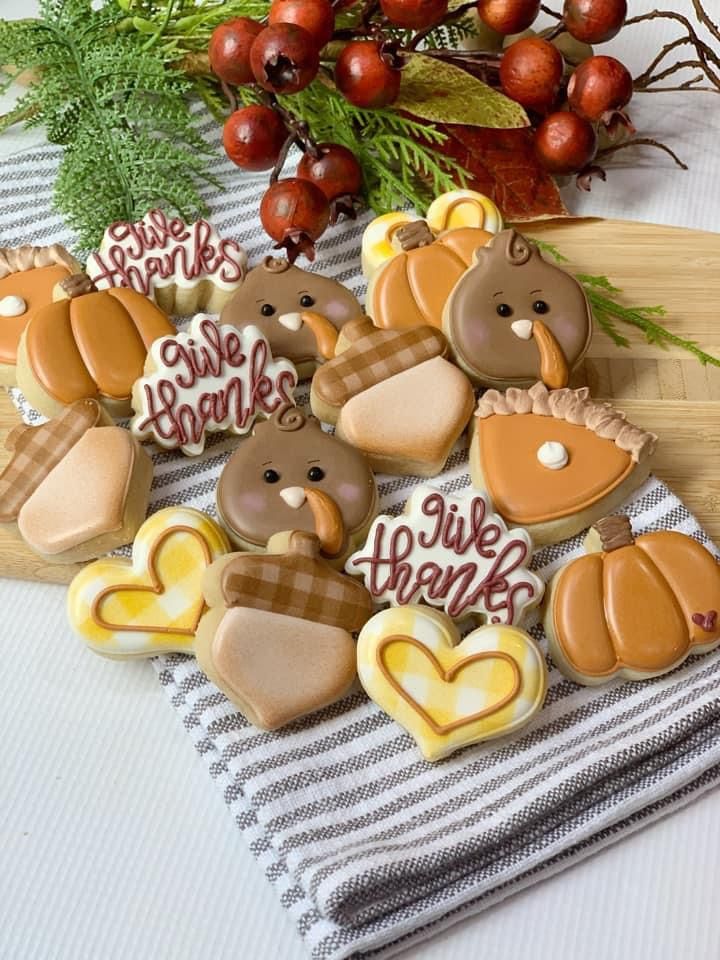 Festive Autumn-Themed Cookies: Playful Pumpkin, Acorn, and Turkey Designs in Warm Tones.