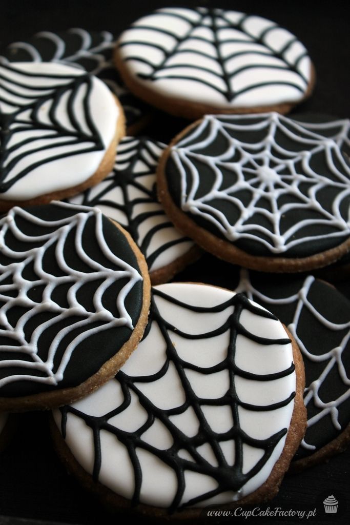 Halloween-Inspired Spiderweb Cookies: A Whimsical Blend of Black and White Icing.