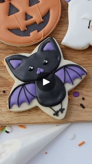 Cute Halloween Bat Cookie: A Festive Treat with Intricate Black and Purple Design.