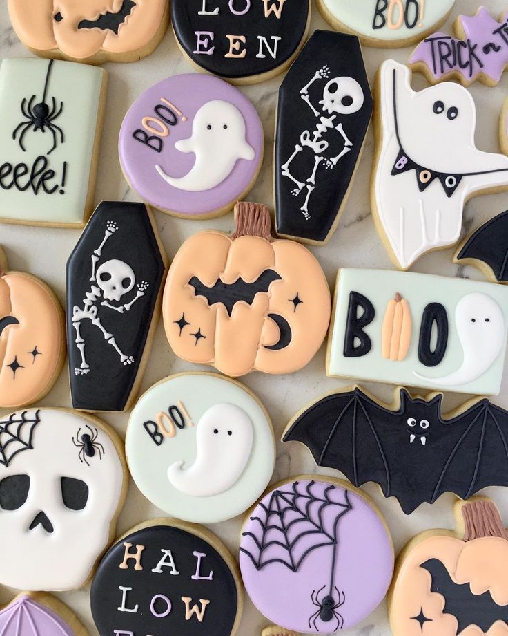 Festive Halloween Cookies with Playful Ghosts, Bats, Skeletons, and Pumpkins.