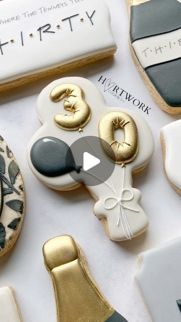 Festive Celebration-Themed Decorative Cookies with Unique Balloon Designs and Elegant Gold Accents.