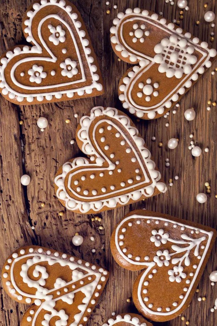 Charming Gingerbread Heart Cookies: Whimsical Icing Designs Inspire Festive Nail Art Ideas.