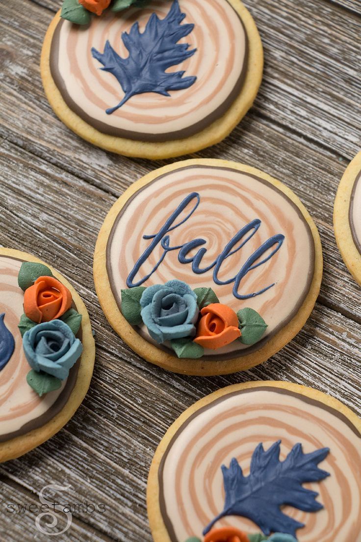 Intricately Designed Autumn Cookies with Wood Grain and Pastel Floral Motifs.