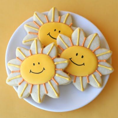 Playful Sun-Shaped Cookies Decorated with Bright Yellow and Orange Icing for Cheerful Celebrations.