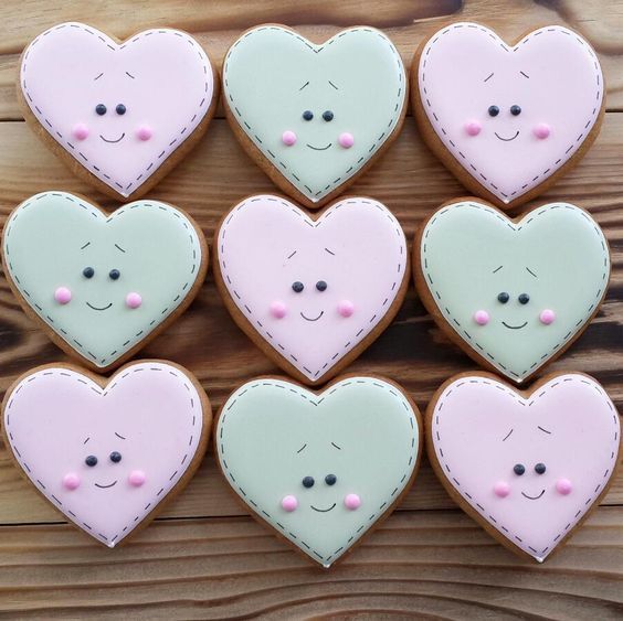 Whimsical Heart-Shaped Cookies with Playful Faces in Sweet Pastel Colors