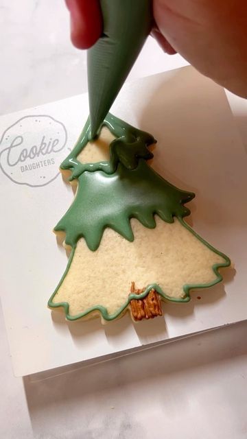 Festive Green Christmas Tree Cookie with Intricate Icing Details.