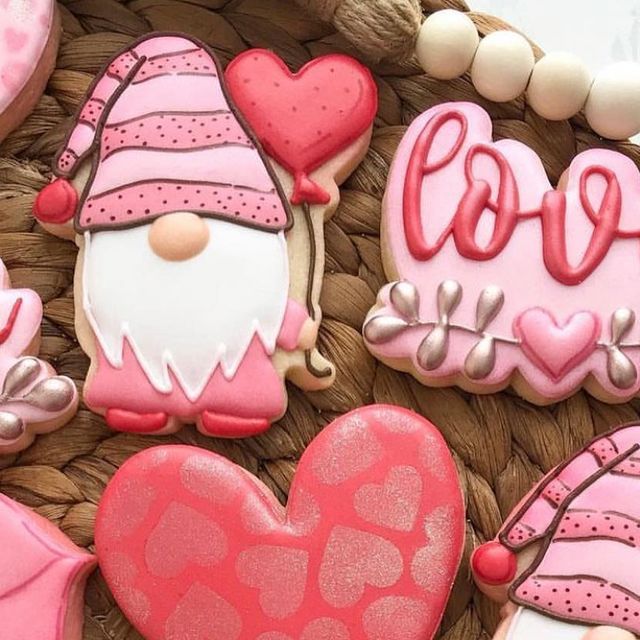 Playful Cookie Designs with Gnome and Heart Motifs in Soft Pink Hues.