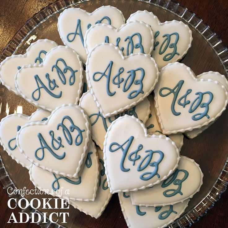 Elegant Heart-Shaped Cookies with White Icing and Blue Lettering for Weddings and Celebrations.