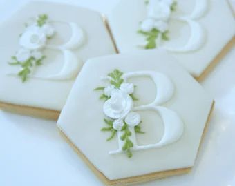 Elegant Floral-Inspired Hexagonal Cookies with Icing Accents: A Sophisticated Treat for Special Occasions and Nail Art Inspiration.