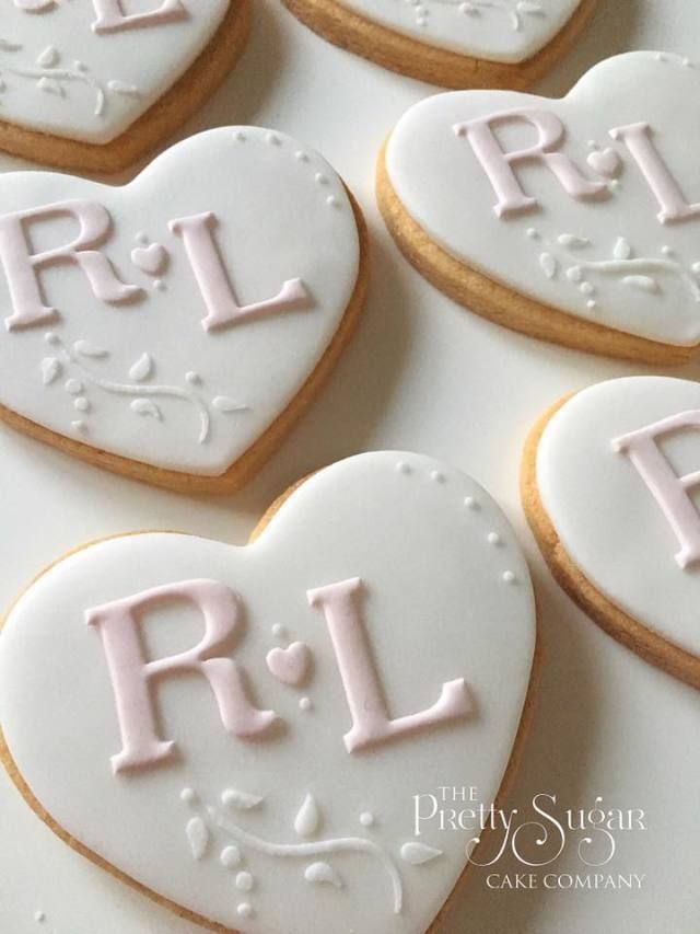 Elegant Heart-Shaped Cookies with Floral Detailing and Personalized Icing.