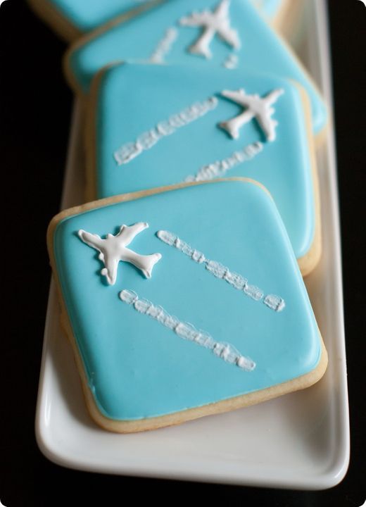 Travel-Themed Cookies with Playful Airplane Design and Vibrant Blue Icing