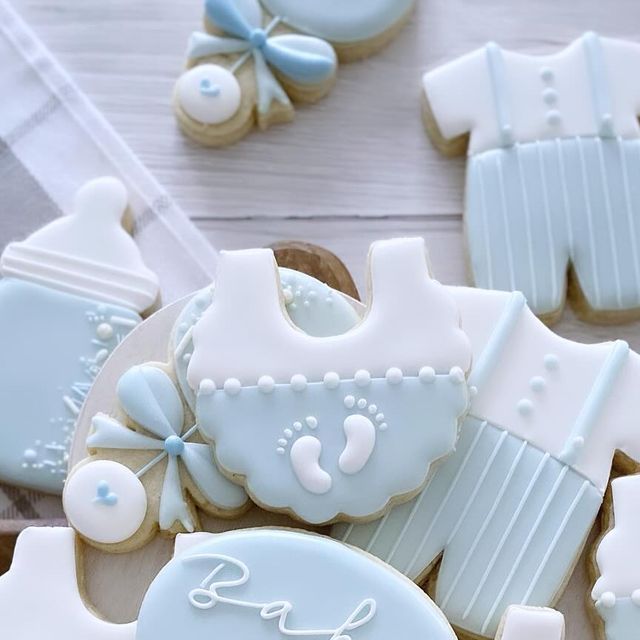 Charming Baby-Themed Decorative Cookies in Blue and White for Celebrations.