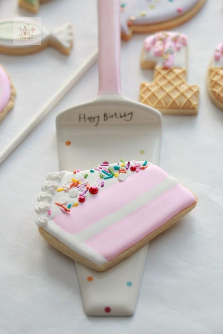 Playful Pastel Cookie Design Featuring Cake Slice on Decorative Spatula.