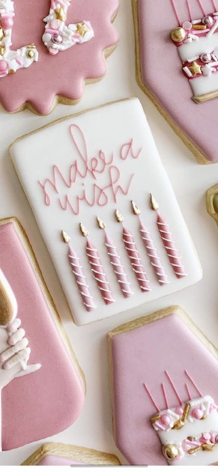 Whimsical Birthday-Themed Cookies in Soft Pink and White with Charming Icing Decor.