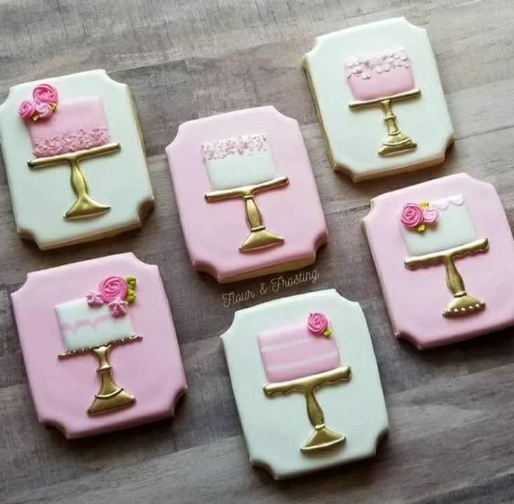 Elegant Decorative Cookies Showcasing Charming Cake Designs on Golden Pedestals.