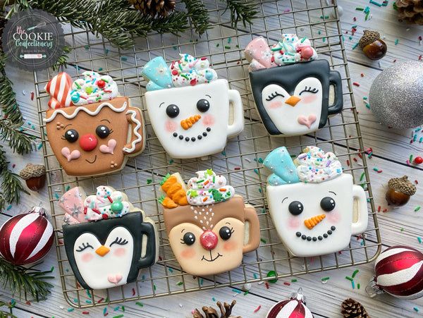 Whimsical Festive Cookie Designs: Cheerful Hot Chocolate Cups and Adorable Penguin Faces Celebrate Winter Holidays.