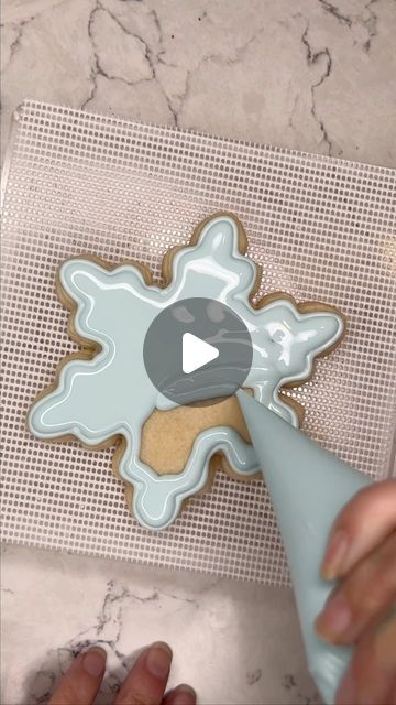 Intricately Designed Snowflake Cookie with Delicate Pastel Blue Icing.