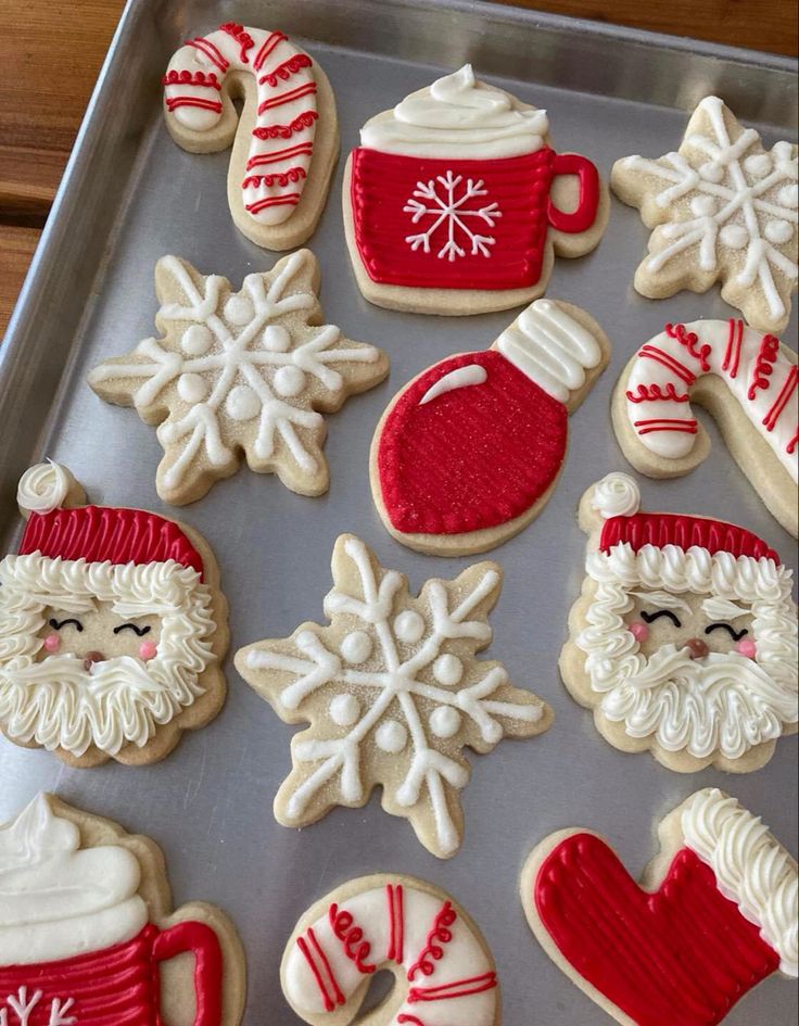 Charming Holiday Cookie Designs: Adorable Santas, Mittens, Snowflakes, and Candy Canes with Intricate Icing.