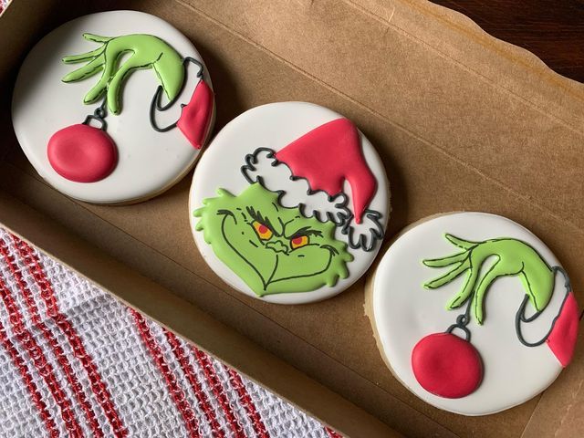 Festive Grinch-Themed Cookies with Colorful Designs and Iconic Motifs.