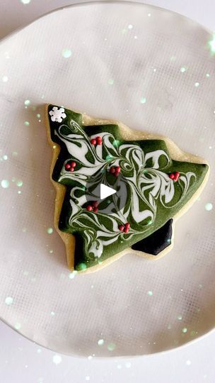 Festive Tree-Shaped Christmas Cookie with Green Icing and Red Berry Accents.