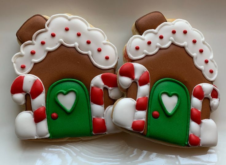 Charming Gingerbread House Cookies with Festive Icing and Candy Cane Details.