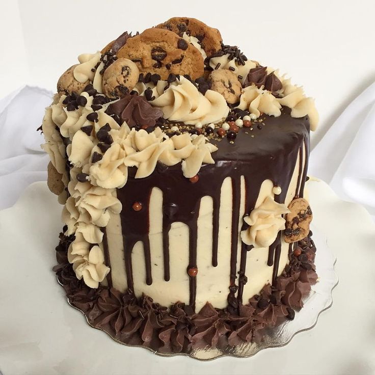 Indulgent Chocolate Cake with Creamy Swirls and Cookie Toppings.