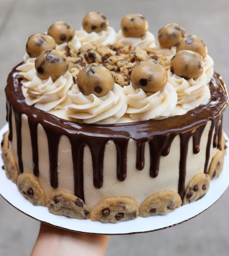 Irresistible Layered Dessert Cake Topped with Chocolate and Cookie Dough.