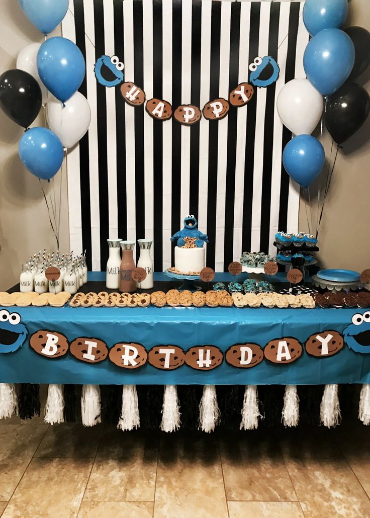 Vibrant Blue and Black Themed Birthday Party with Festive Dessert Table and Balloon Decor.