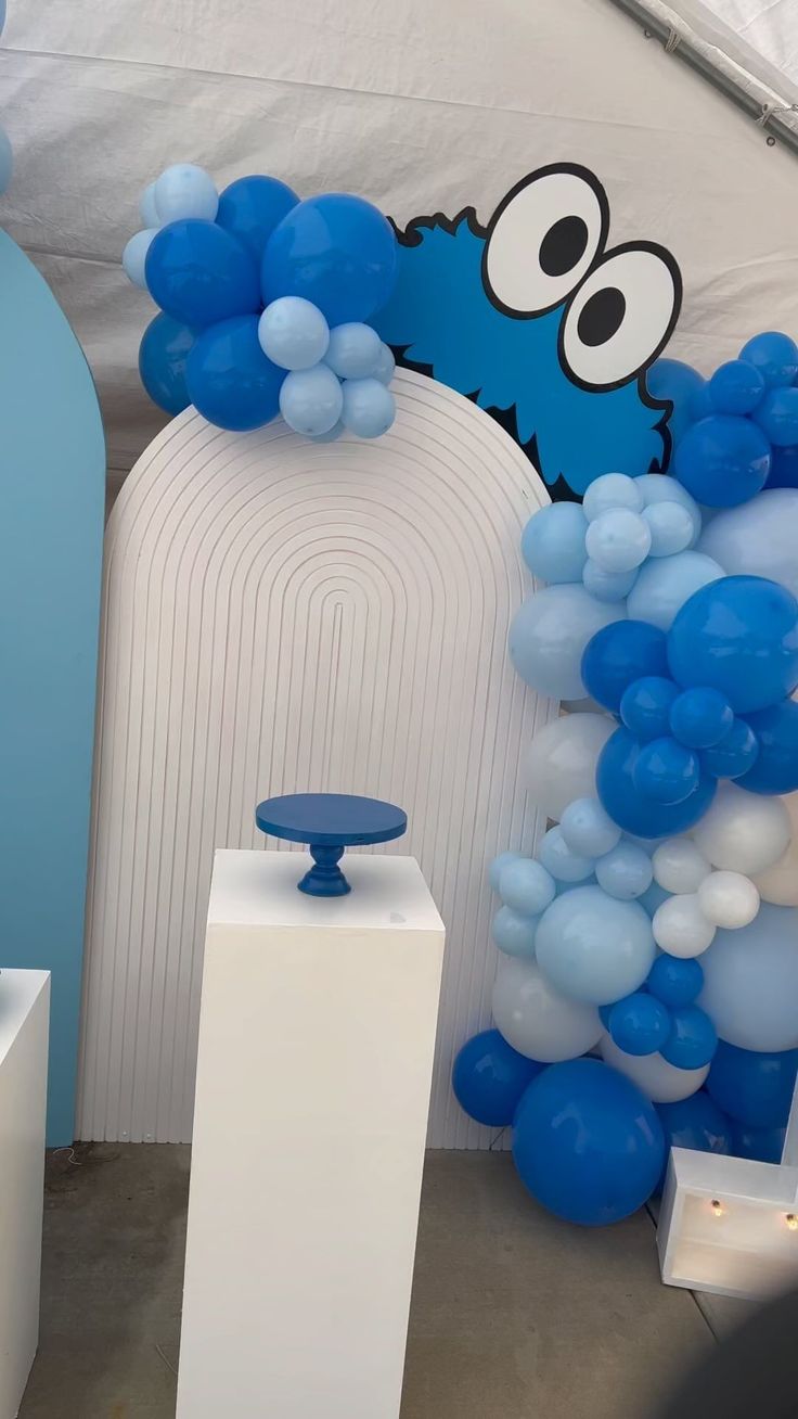 Whimsical Blue Balloon Arrangement with Elegant Pedestal for Celebrations and Nail Art Displays.