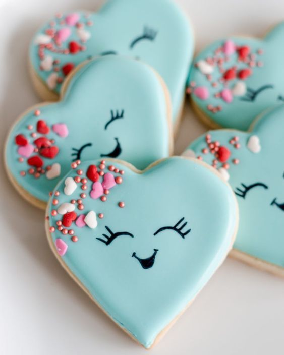 Cheerful Heart-Shaped Cookies Adorned with Bright Blue Icing and Playful Decorations.