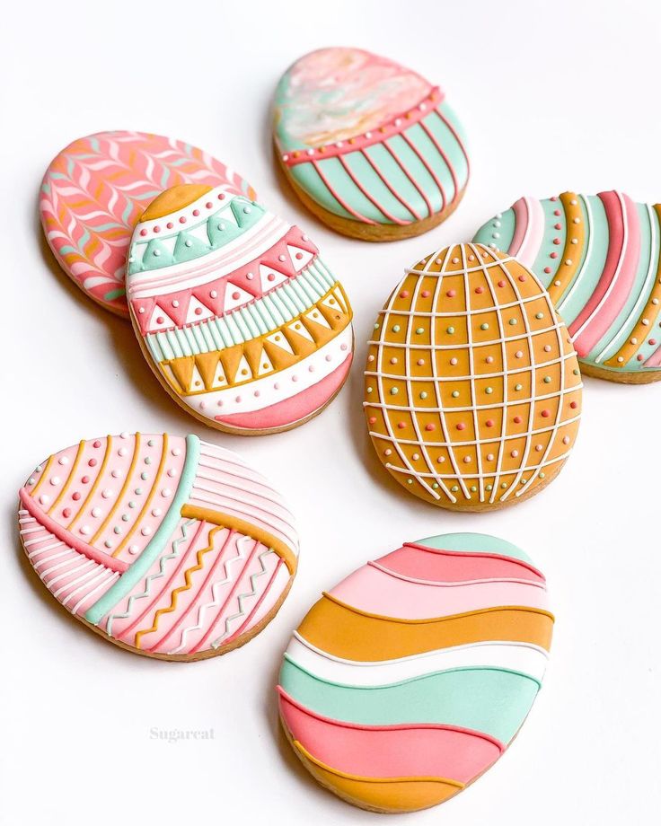 Intricately Designed Egg-Shaped Cookies: A Festive Display of Colorful Patterns and Gold Accents.