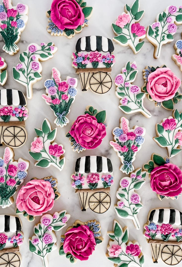 Vibrant Floral-themed Cookies with Artistic Icing and Whimsical Cart Design.