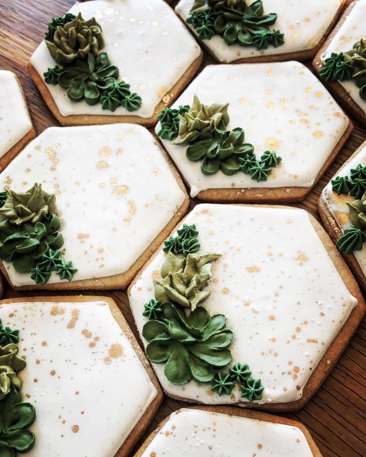 Elegant Hexagonal Cookies with Intricate Green Floral Designs and Golden Accents for Celebrations.