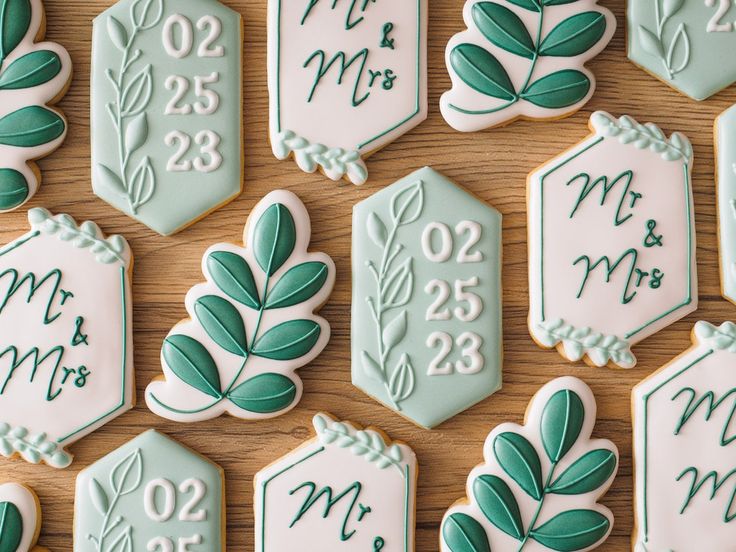 Sophisticated Mint Green and White Cookie Designs for Weddings with Modern Geometric Shapes and Leaf Patterns.