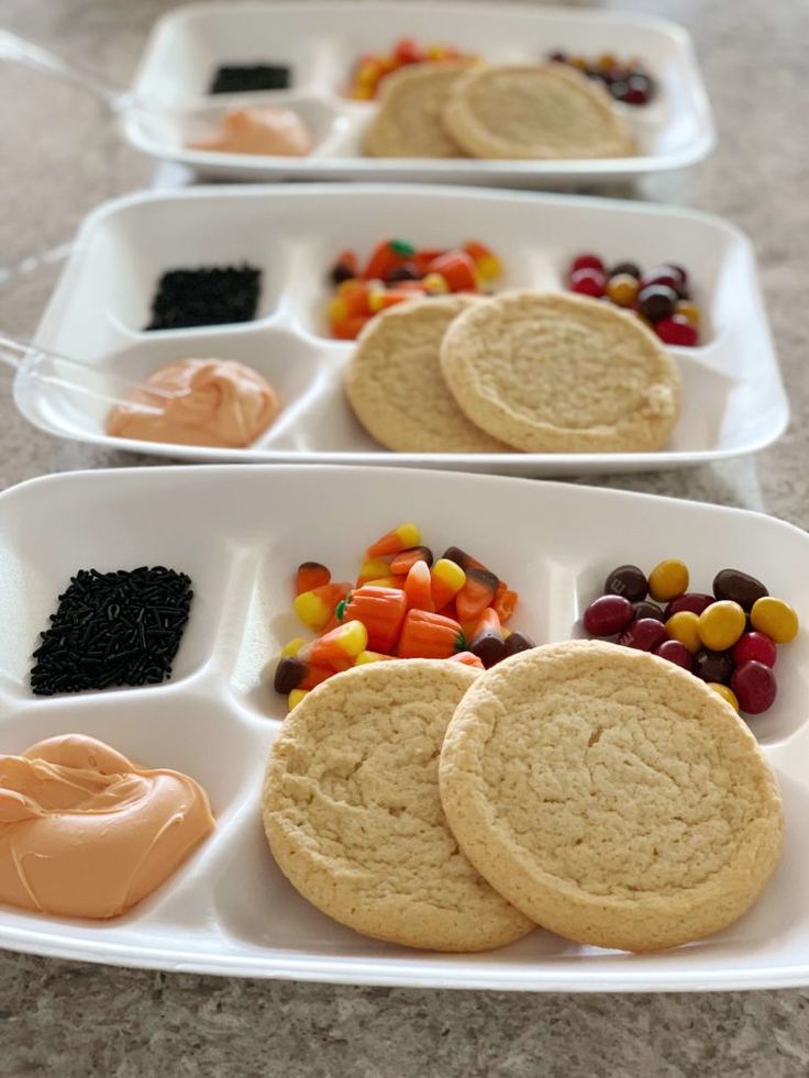 Vibrant Dessert Platter: Sugar Cookies, Candy Corn, Chocolates, and Creamy Spreads.