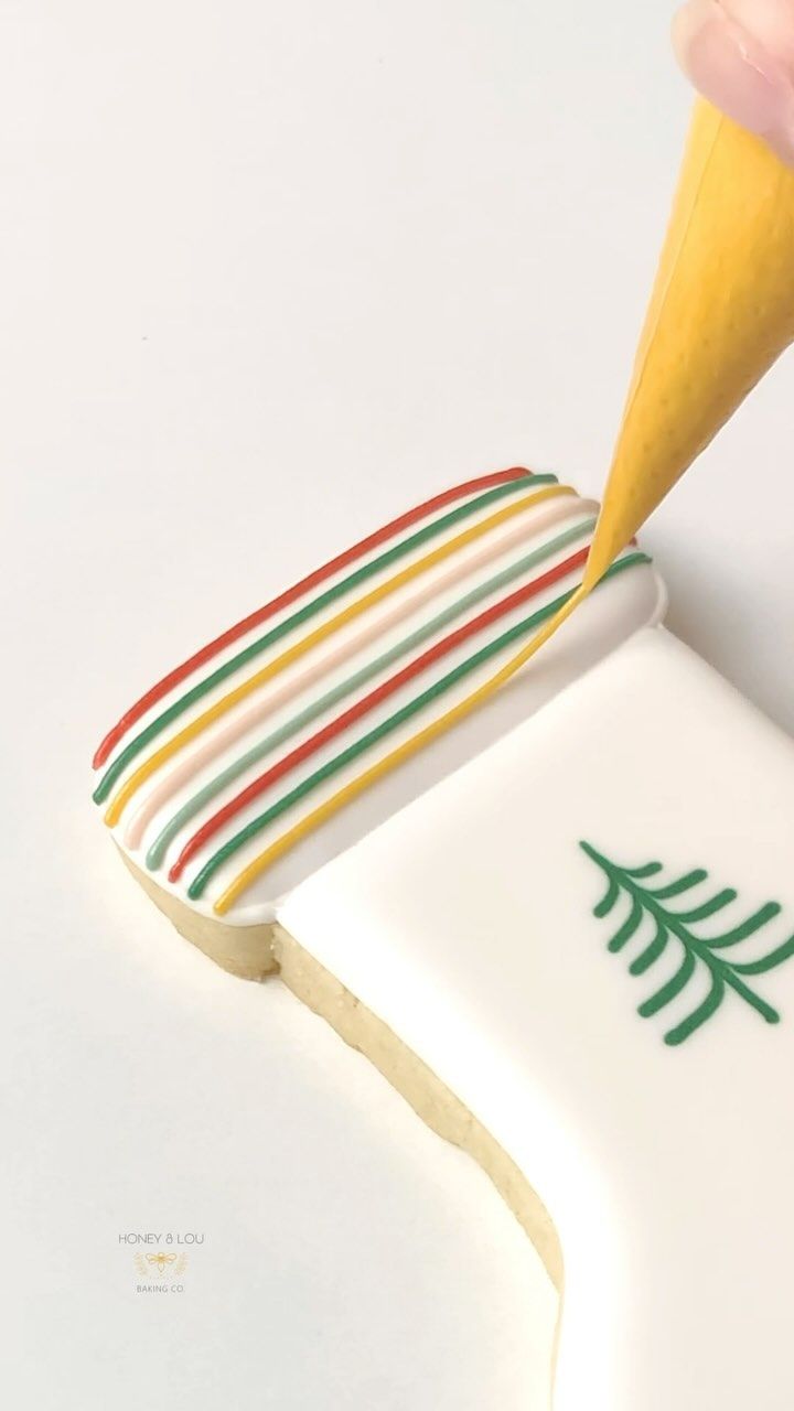 Festive Cookie Design with Vibrant Stripes and Delicate Leaf Motif.