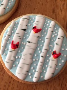 Winter Cookie Design: Serene Blue Background with White Birch Trees, Red Cardinals, and Delicate Snowflakes.