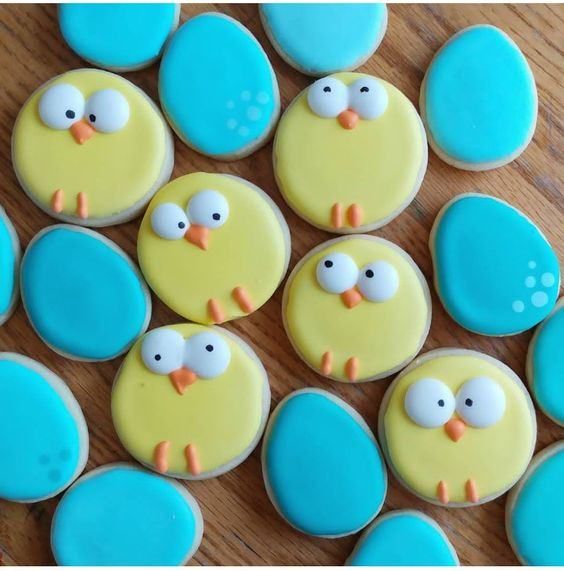 Playful Display of Colorful Cookies: Cheerful Chicks and Vibrant Blue Eggs for Festive Celebrations.