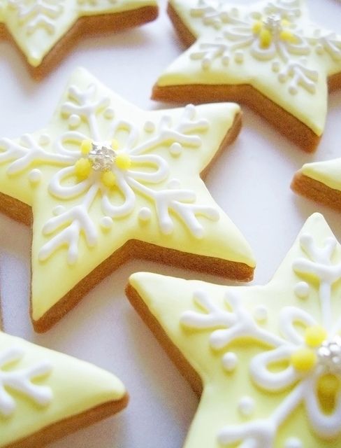 Whimsical Star-Shaped Cookies: Pastel Yellow Base with Delicate Icing and Shimmering Accents.