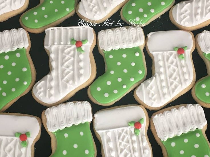 Festive Stocking-Shaped Decorative Cookies with Intricate Green, White, and Red Designs for Holiday Celebrations.