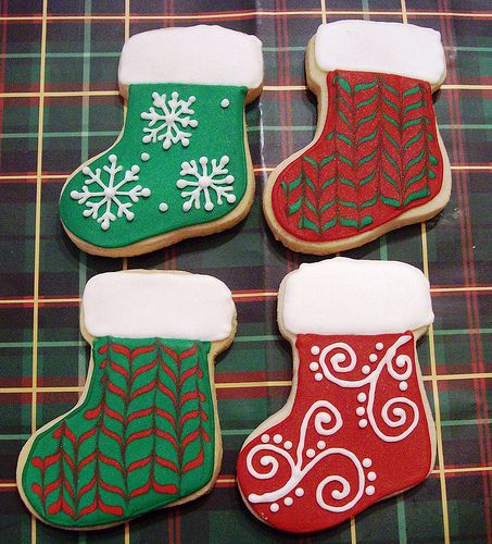 Festively Designed Stocking-Shaped Cookies with Intricate Patterns for Holiday Gatherings.