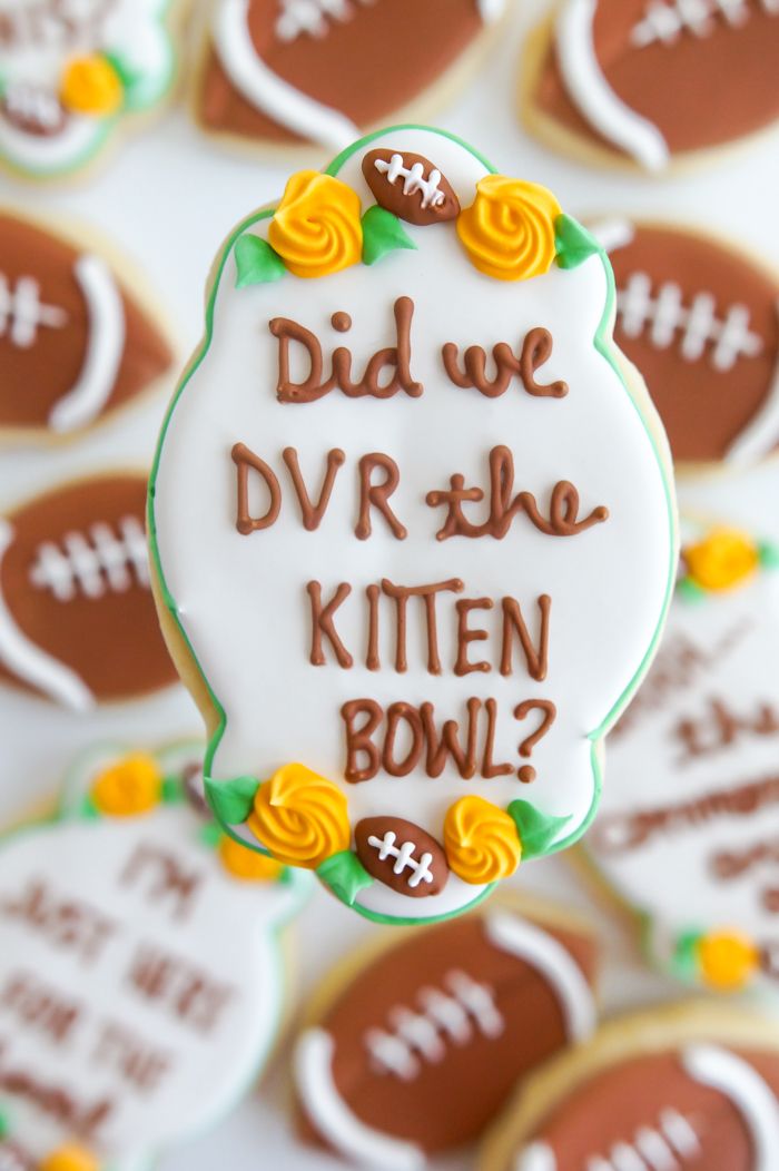 Playful Football-Themed Decorative Cookies with Cheerful Floral Accents for Festive Gatherings.