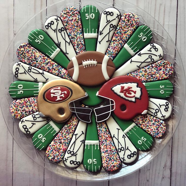 Festive Football-Themed Cookie and Cupcake Arrangement for Sports Gatherings.